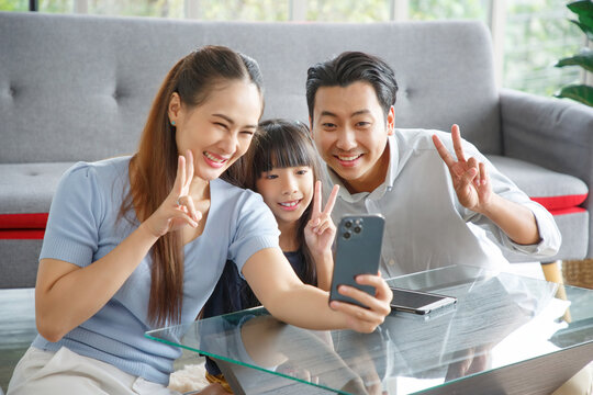Happy asian family taking selfie at home.Family,love and happiness concept.