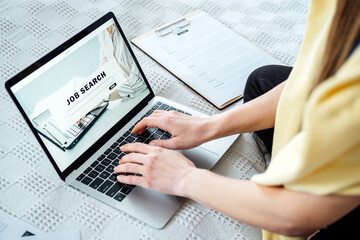 Job Search Career Recruitment Hiring Website Concept. Young woman in home browsing work opportunities online using job search web sites and applications