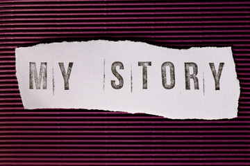 Text My Story made of rubber stamp on torn paper and striped background.
