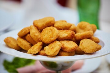 Deep-fried chicken meat. Fast food on the table.