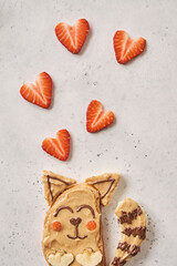 Funny cute cat sandwich with peanut butter, banana and strawberry for kids