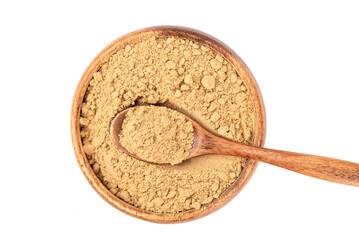 Spoon in a wooden bowl full of ground ginger root on a white background.