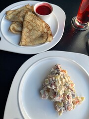 Olivier salad and pancakes with jam