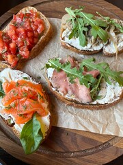 Bruschetta with fish, tomatoes and mushrooms