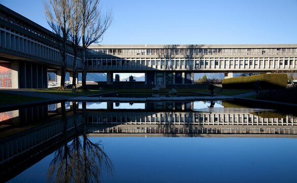 Modern bridge building reflected on the water surface. Simon Fraser University, Vancouver, Canada.