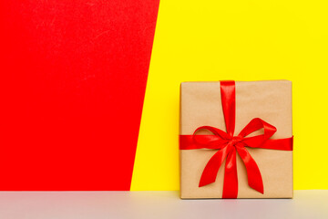 holiday brown paper present tied red ribbon bow top view with copy space. Flat lay holiday background. Birthday or christmas present. Christmas gift box concept with copy space