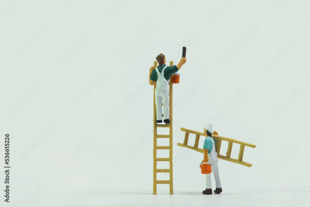 Wall mural Painter with ladder at work isolated on white background