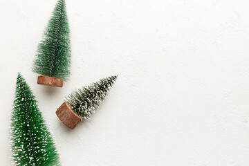 Flat lay composition with christmas trees on color background. Top view with copy space