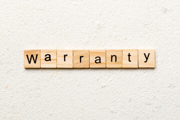 warranty word written on wood block. warranty text on table, concept