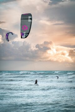 People kitesurfing in Kourion beach during sunset
