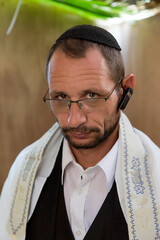 Religious jewish men in traditional jewish male headdress, hat, kippah in sukkah. Serious Israel...