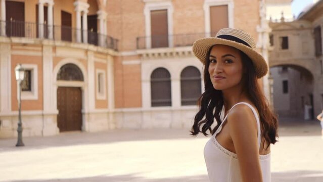 Attractive elegant female walking on the streets in Valencia