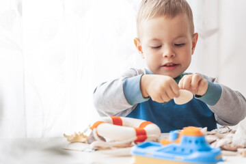 Child play with sea shells and boats. Summer vacation and travel concept. Kid play with lifebuoy...