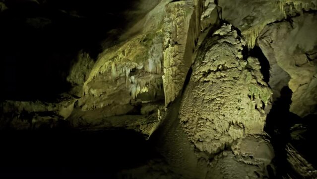 Beautiful cave with stalactites underground cavern in magic light, panorama view 4k