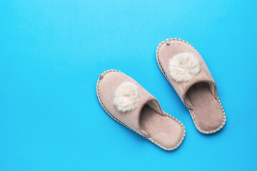 Warm slippers on a blue background. The concept of home shoes.