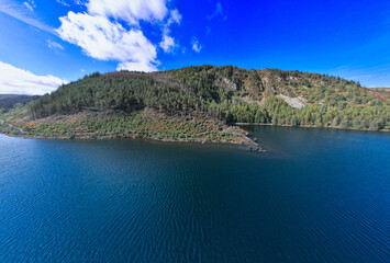 Llyn Geirionydd lies in a valley in North Wales where the northern edge of the Gwydyr Forest meets the lower slopes of the Carneddau mountains. The lake is almost a mile long and covers an area of 45 