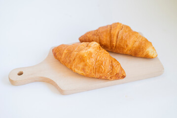 sweet breakfast croissants pastry on wooden board on white background
