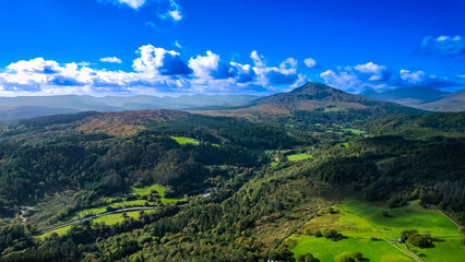 Obraz premium Snowdonia mountains as seen from the Gwydyr Forest which meets the lower slopes of the Carneddau mountains. 