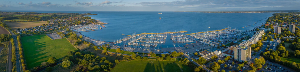 Panorama aerial view of marina Schilksee with sailing boats docked at the pier. Aerial view of...