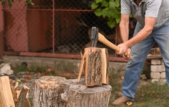 A lumberjack is chopping wood with an axe.