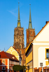 St. John Baptist gothic cathedral on Ostrow Tumski Island at Odra river in historic old town quarter of Wroclaw in Poland - obrazy, fototapety, plakaty