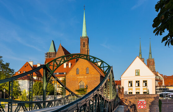 Panoramic view of Ostrow Tumski Island with Holy Cross collegiate cathedral and Most Tumski Bridge over Odra river in historic old town quarter of Wroclaw in Poland © Art Media Factory