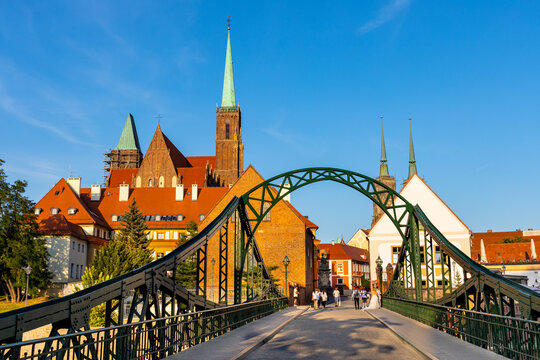 Panoramic view of Ostrow Tumski Island with Holy Cross collegiate cathedral and Most Tumski Bridge over Odra river in historic old town quarter of Wroclaw in Poland © Art Media Factory