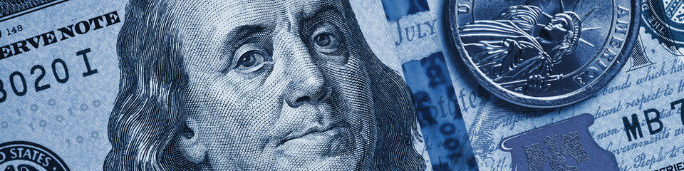 American money close-up. 100 dollar note and 1 dollar coin. Benjamin Franklin and Statue of Liberty. Blue tinted banner or header about US economy. Public debt and USA dollars. Reserve currency. Macro