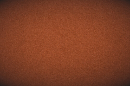 Bright brown colored paper texture. Dark orange tinted background or wallpaper with vignetting. Textured surface, fibers and irregularities are visible. Top-down