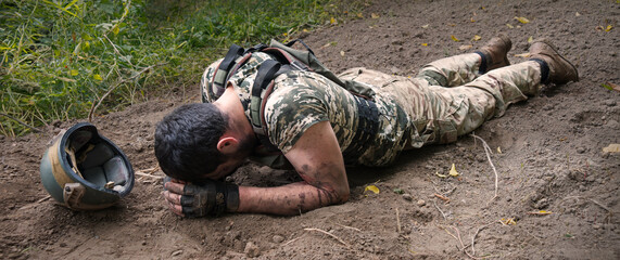Sad soldier laying on the ground
