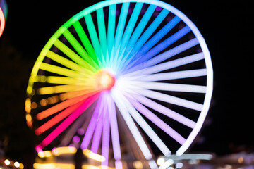 blurred silhouette of illuminated ferris wheel park