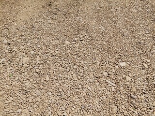 Paved road, thousands of pebbles, gravel, road before asphalting