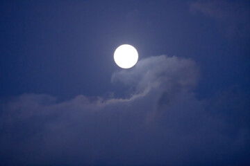 Full moon in a blue sky