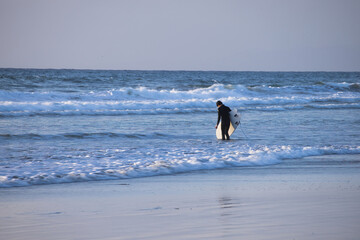 Surfer going out in the waves