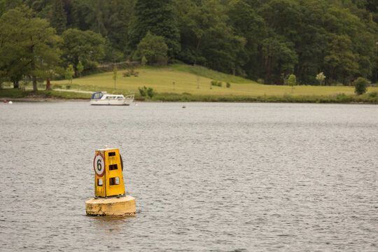 A yellow speed limit Buoy on a inland lake