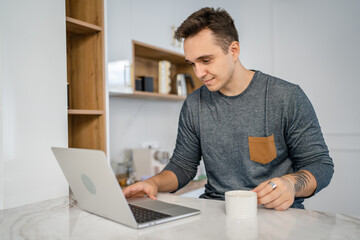 one man caucasian male use laptop computer in the morning