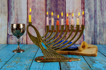 Menorah candles are lit by Jew preparation for Hanukkah with Jewish symbols