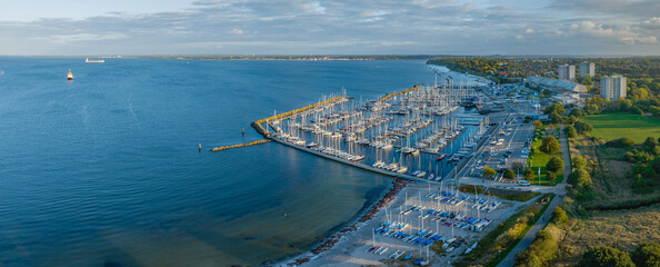 Aerial view of marina Schilksee with sailing boats docked at the pier. Aerial view of popular...