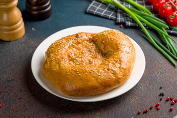 Uzbek bread from tandoor on dark concrete table