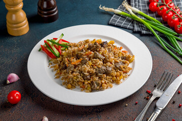 pilaf with beef on dark stone table