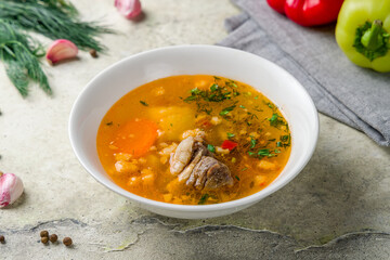 shurpa asian soup with lamb on stone table