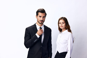 A man and a business woman in business attire look at the camera against a white, isolated background. Stylish business concept paired between employees startup copy space