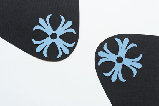 decorative rosettes on black paper shapes with white space - Powered by Adobe