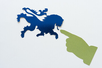 green pointing finger at blue heraldic lion glyph or dingbat