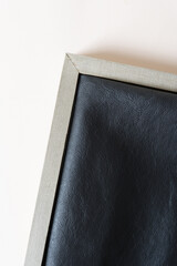 wood frame with folded leather on blank paper