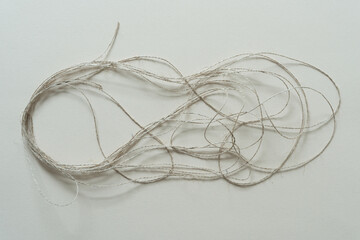 length of brown twine or string on paper
