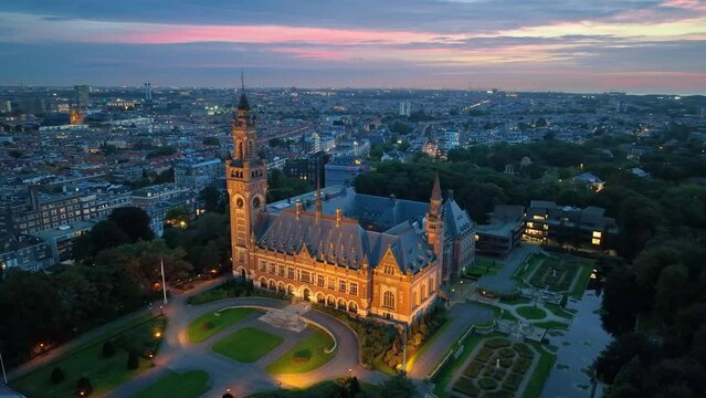 Aerial city night illumination famous Peace Palace Vredespaleis. The cityscape of Den Haag in an aerial shot. Netherlands