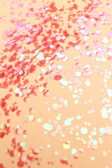 Naklejka premium Shiny bright red glitter on beige background