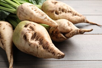 Fresh sugar beets on wooden table, closeup view