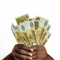 Black hands holding 3D rendered Zambian Kwacha notes. closeup of Hands holding Zambian currency...